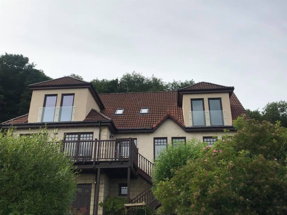 2 - 10mm clear toughened Juliet balconies fitted using stainless steel stand off fixings to dormers in Dalgety Bay